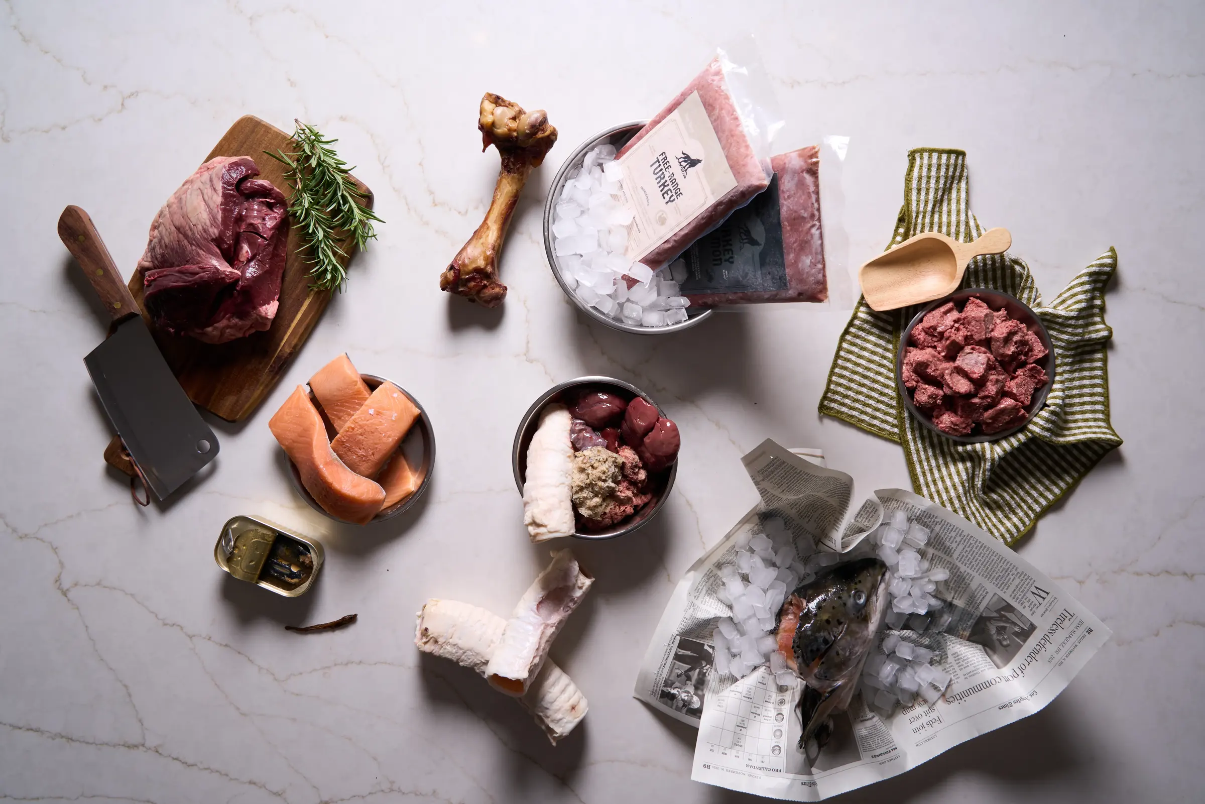 Raw Dawg frozen raw recipes arranged on a light preparation surface